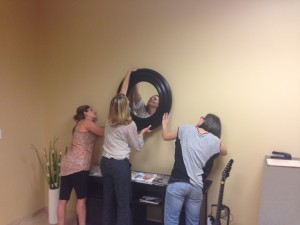 jana usseton putting a mirror up